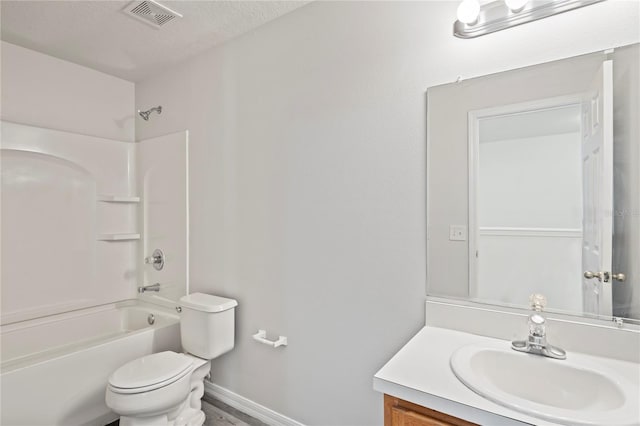 full bathroom with a textured ceiling, vanity, toilet, and bathing tub / shower combination