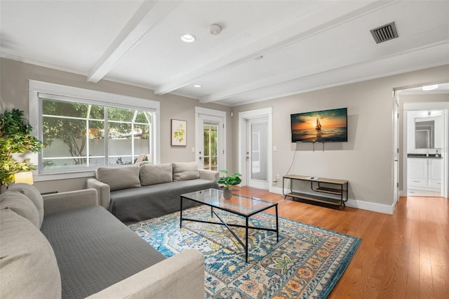 living room featuring light hardwood / wood-style floors and beamed ceiling