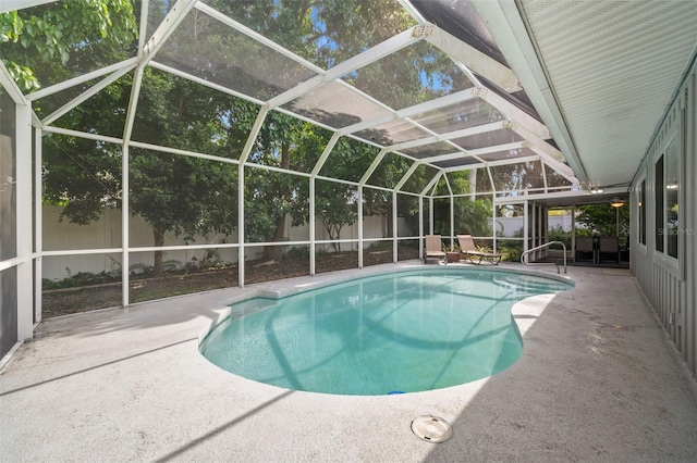 view of swimming pool with a patio area and a lanai