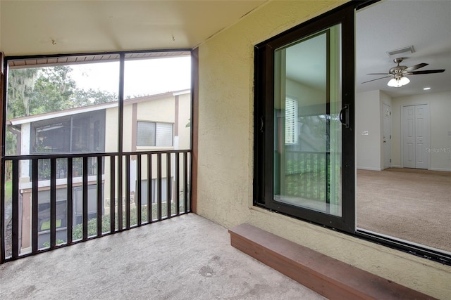 unfurnished sunroom with ceiling fan