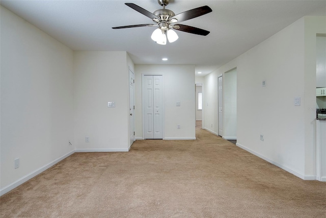 carpeted empty room with ceiling fan