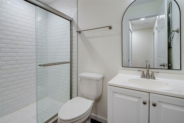 bathroom featuring vanity, toilet, and an enclosed shower