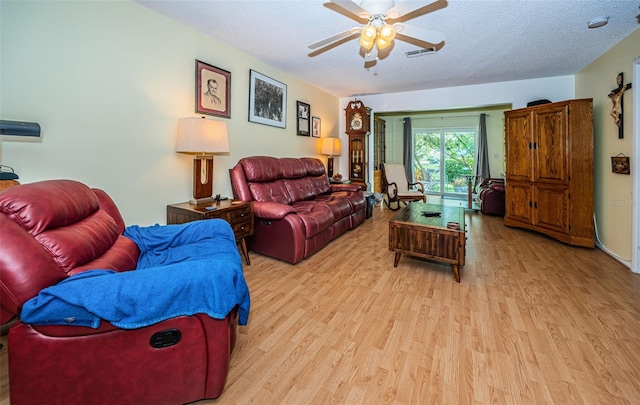 living room with ceiling fan, a textured ceiling, and light hardwood / wood-style flooring