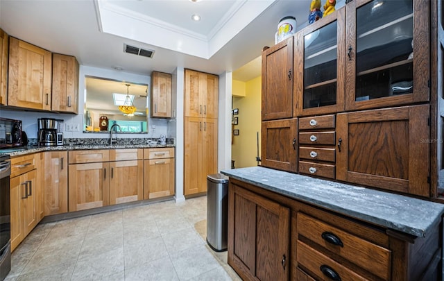 kitchen featuring sink, stone counters, a tray ceiling, and light tile patterned flooring