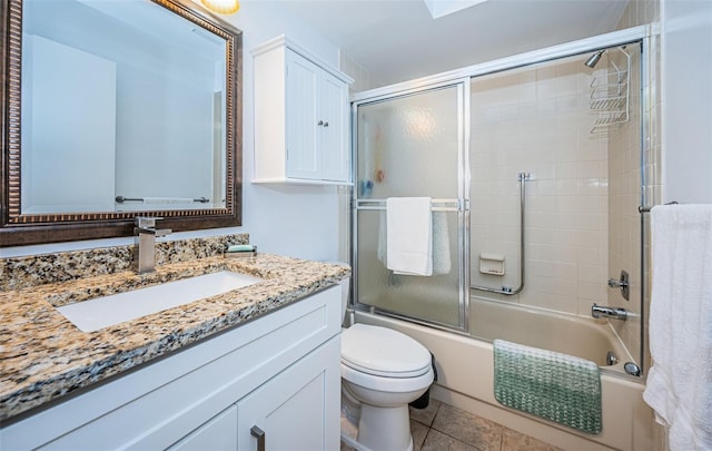 full bathroom featuring tile patterned floors, toilet, vanity, and enclosed tub / shower combo