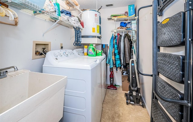 laundry area with washing machine and dryer, light tile patterned floors, sink, a textured ceiling, and electric water heater