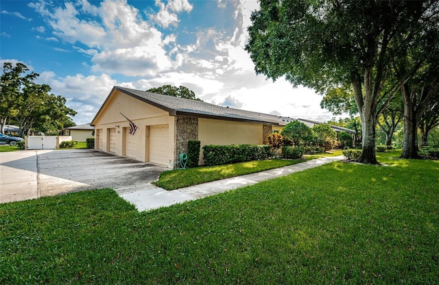 view of side of home featuring a garage and a yard