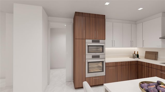 kitchen featuring white cabinetry and stainless steel double oven