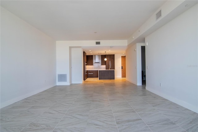 unfurnished living room with visible vents