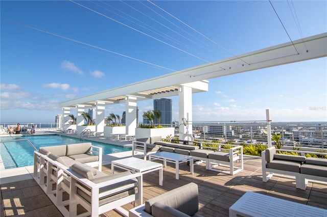 view of patio / terrace featuring outdoor lounge area, a community pool, and a city view