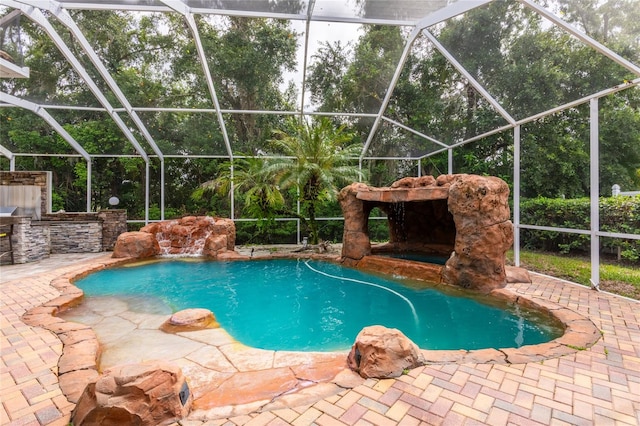 view of swimming pool with glass enclosure and a patio