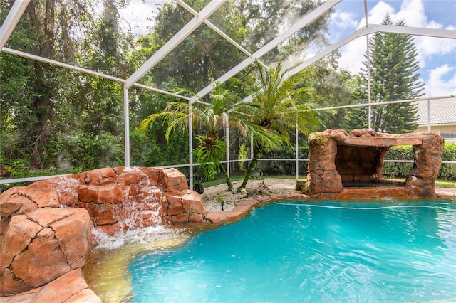 view of pool with glass enclosure and pool water feature