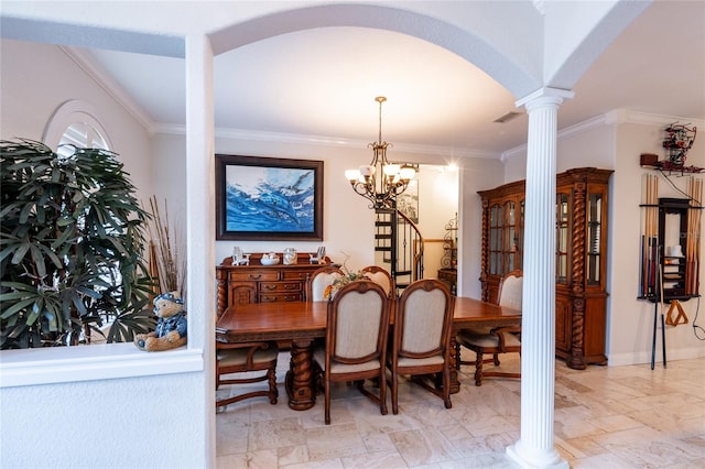 dining area with ornamental molding, an inviting chandelier, and ornate columns