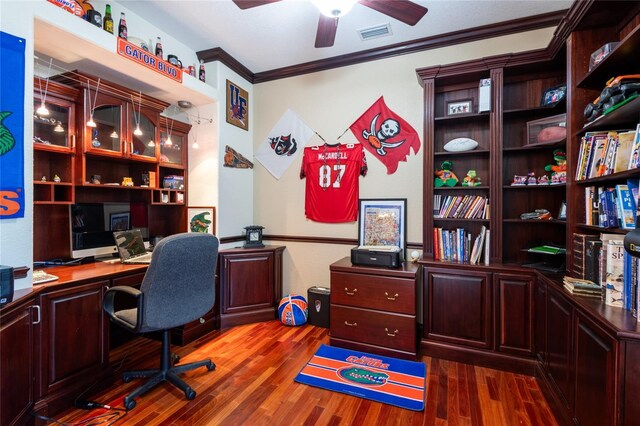 home office featuring ceiling fan, dark hardwood / wood-style floors, and crown molding