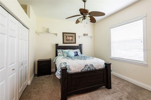 carpeted bedroom featuring a closet and ceiling fan