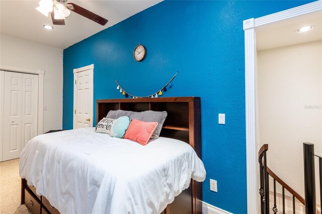 bedroom featuring carpet, ceiling fan, and a closet