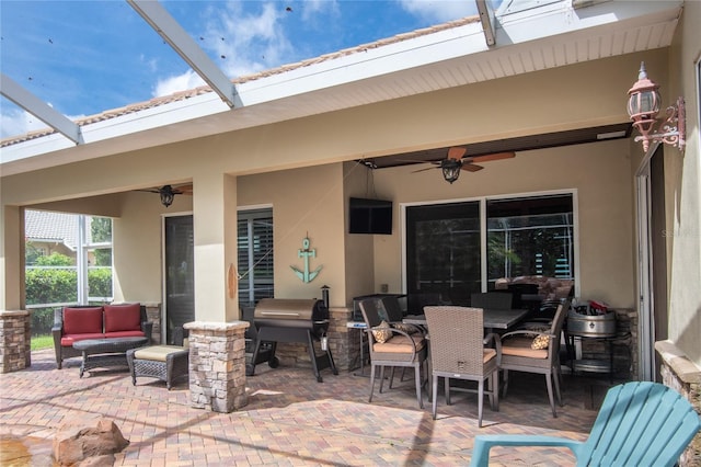 view of patio featuring a grill, ceiling fan, an outdoor hangout area, and a lanai