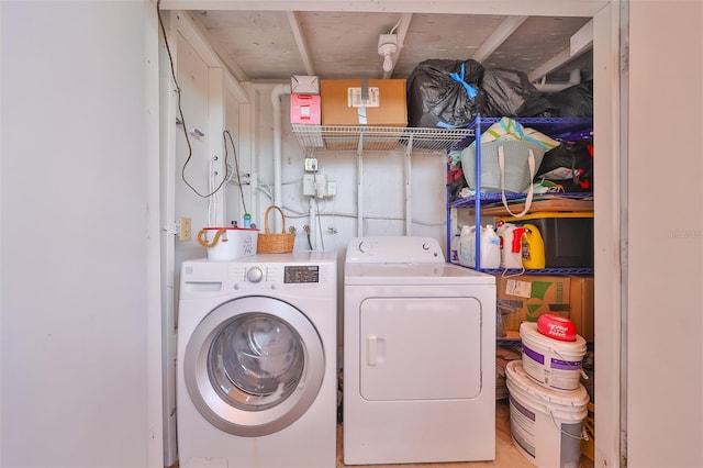 clothes washing area with washing machine and clothes dryer