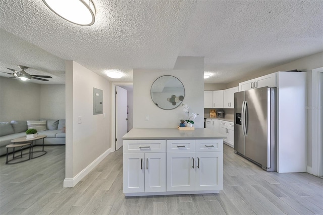 kitchen with ceiling fan, light wood-type flooring, white cabinets, and stainless steel refrigerator with ice dispenser