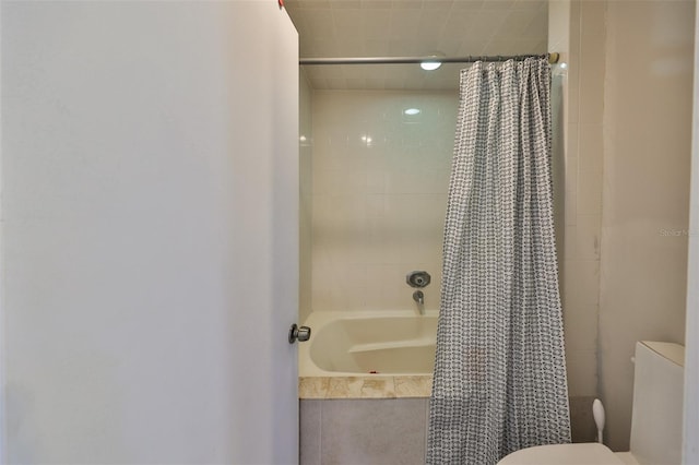 bathroom with toilet and shower / tub combo