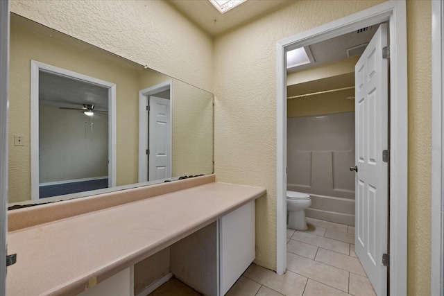 bathroom with toilet, shower / bath combination, tile patterned floors, and ceiling fan