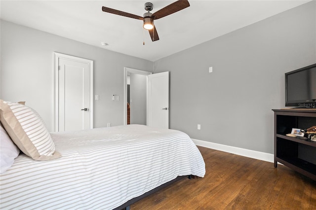 bedroom featuring wood finished floors, a ceiling fan, and baseboards