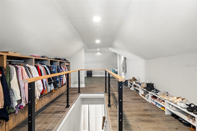 walk in closet with vaulted ceiling and hardwood / wood-style floors