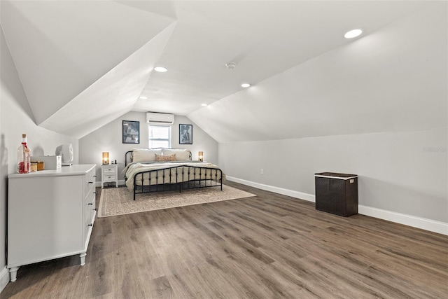 bedroom with lofted ceiling, wood-type flooring, and a wall mounted air conditioner