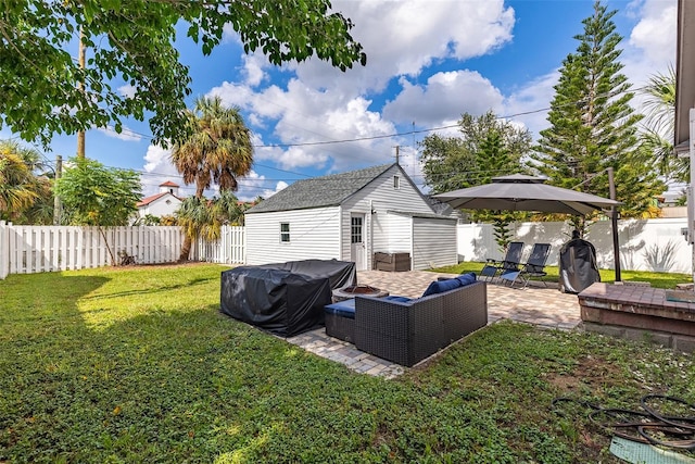 view of yard with a fire pit, a patio area, and an outbuilding