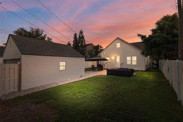 yard at dusk with a patio area