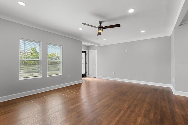 empty room featuring recessed lighting, wood finished floors, a ceiling fan, and baseboards