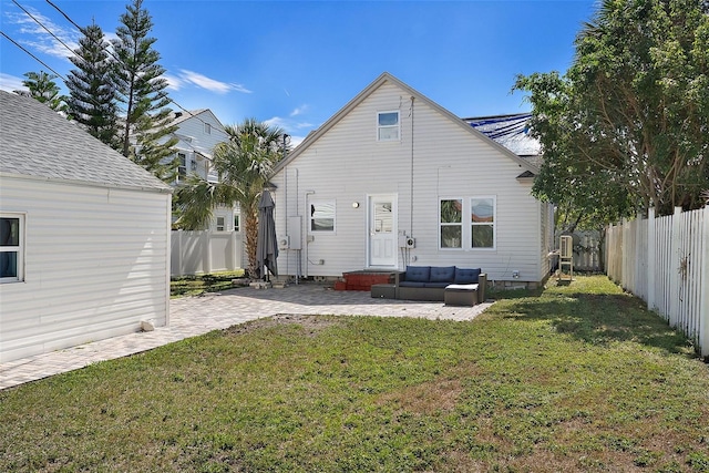 rear view of property featuring a yard, a fenced backyard, a patio, and an outdoor living space