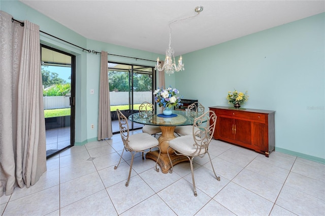 dining space with light tile patterned flooring, baseboards, and an inviting chandelier