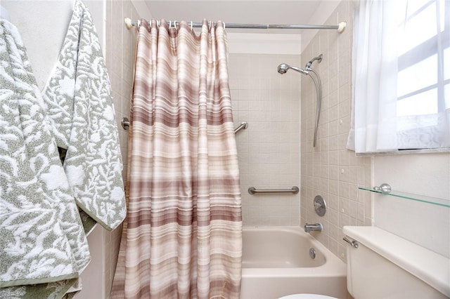 bathroom featuring shower / bath combo with shower curtain and toilet