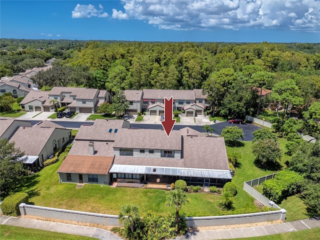 birds eye view of property with a residential view and a view of trees