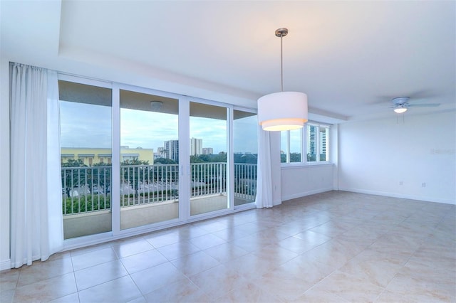 tiled spare room with ceiling fan