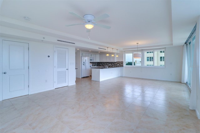 unfurnished living room with ceiling fan and light tile patterned flooring