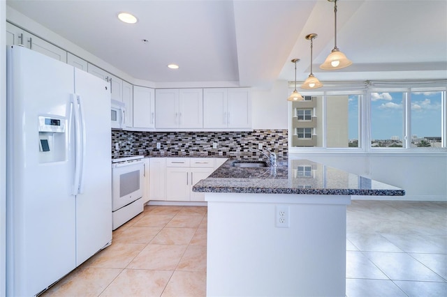 kitchen with white cabinets, hanging light fixtures, white appliances, sink, and kitchen peninsula