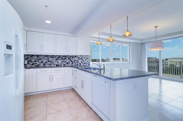 kitchen with sink, decorative light fixtures, white appliances, and white cabinetry