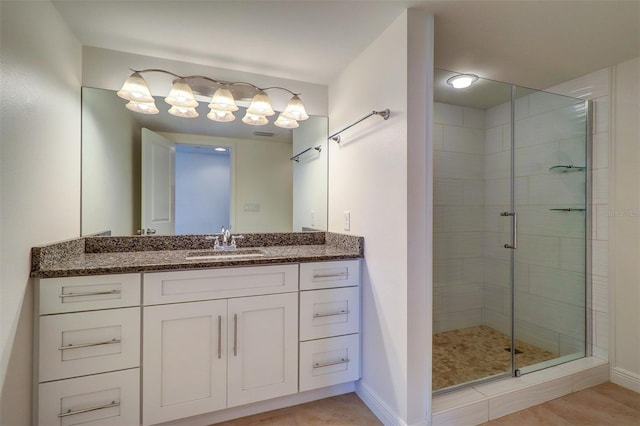 bathroom featuring vanity and an enclosed shower