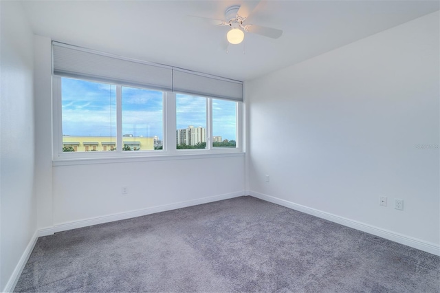 unfurnished room with plenty of natural light, ceiling fan, and carpet floors