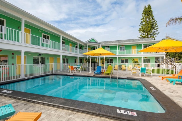 view of pool featuring a patio area and fence