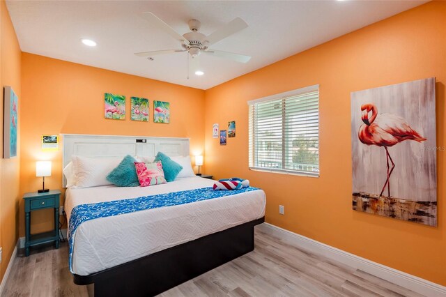 bedroom with ceiling fan and light wood-type flooring