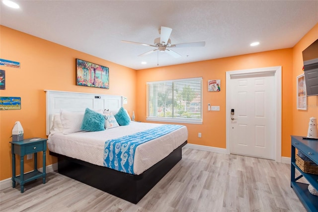 bedroom with ceiling fan and light hardwood / wood-style flooring