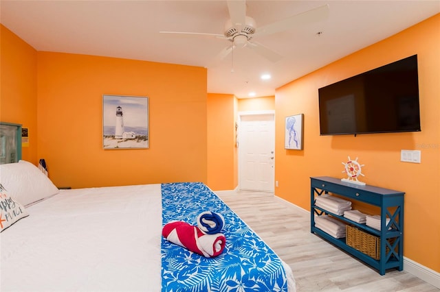 bedroom with ceiling fan and light hardwood / wood-style flooring