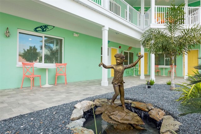 view of patio featuring a balcony