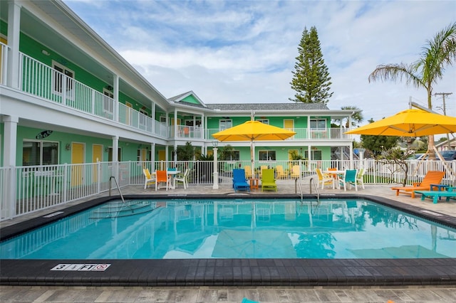 pool featuring a patio area and fence