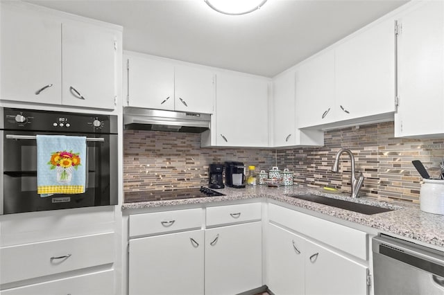 kitchen featuring sink, decorative backsplash, white cabinets, and stainless steel appliances