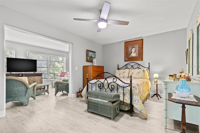 bedroom with ceiling fan and light wood-type flooring