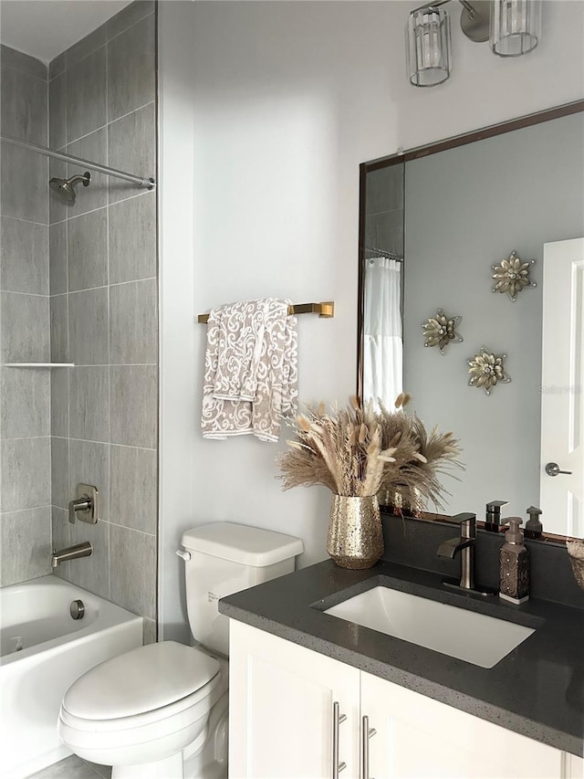 bathroom featuring toilet, vanity, and bathing tub / shower combination